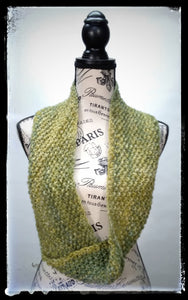"Meadow" Hand Knit Twisted Infinity Scarf was created with Berroco Air blown bulky weight yarn in Geothermal colorway, worn long.