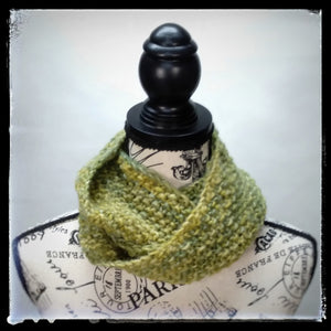 "Meadow" Hand Knit Twisted Infinity Scarf was created with Berroco Air blown bulky weight yarn in Geothermal colorway, worn wrapped.
